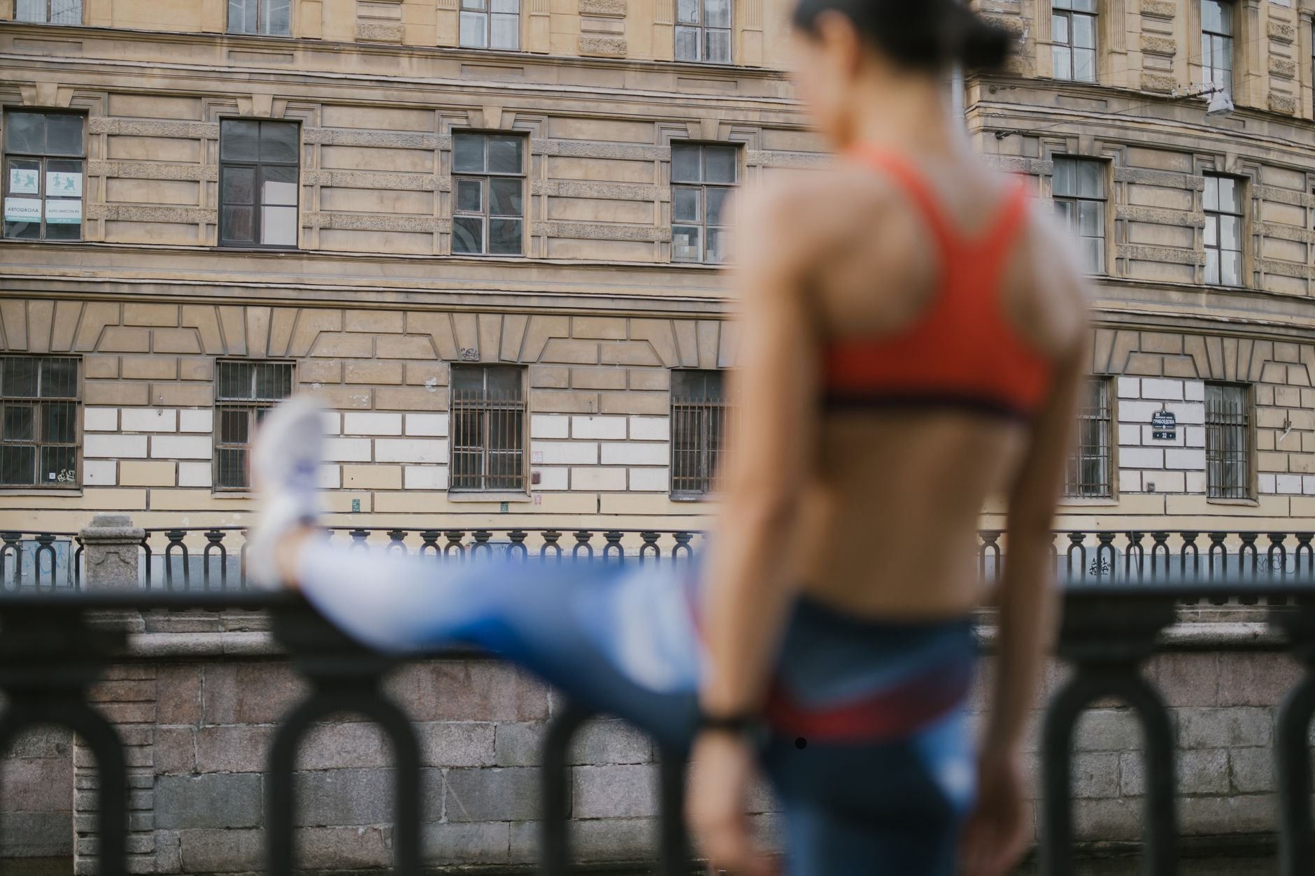 A woman exercising outdoors, focused on her fitness journey