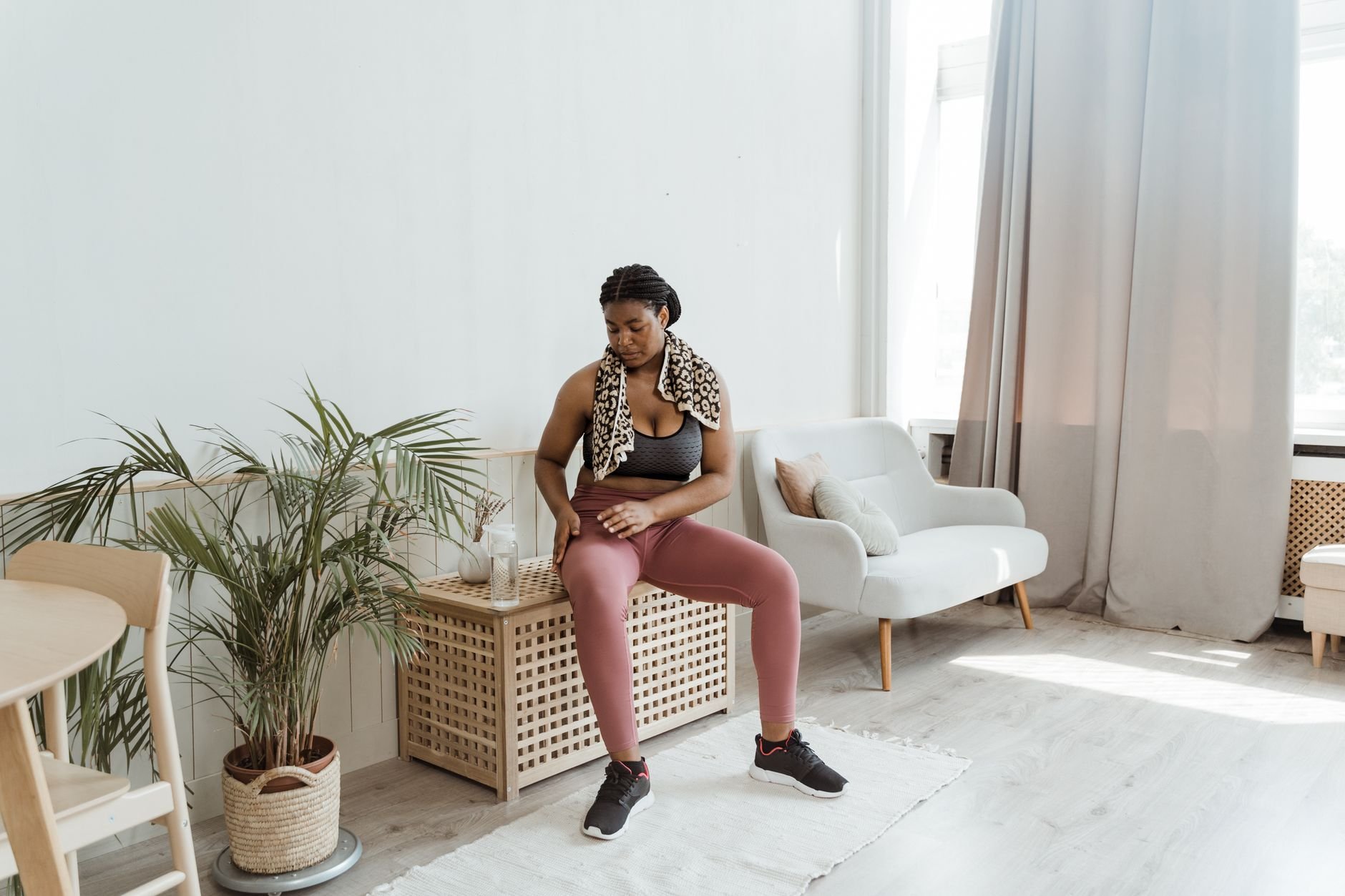 Woman in activewear resting after an outdoor workout session