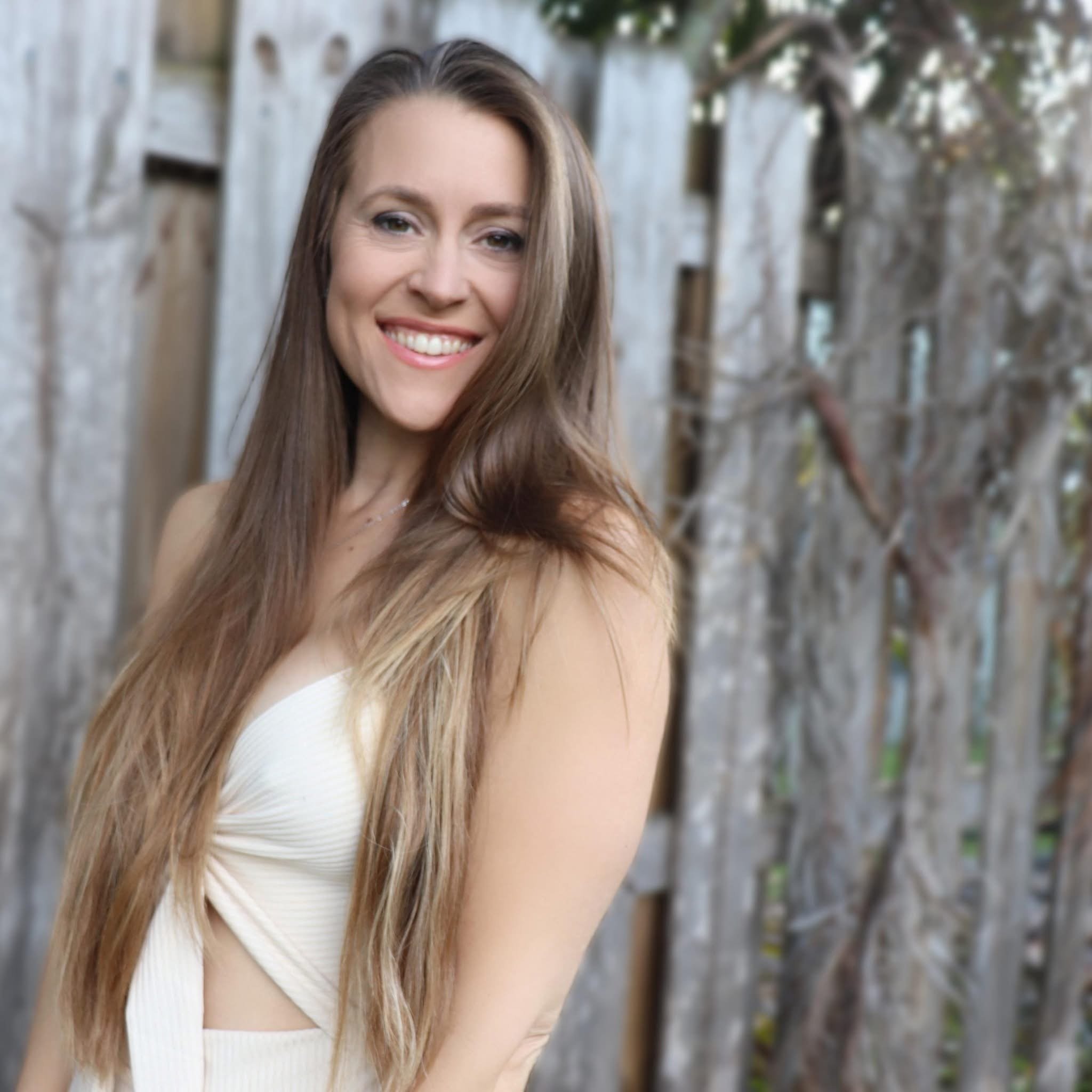 Your personal trainer smiling outdoors, warm and approachable